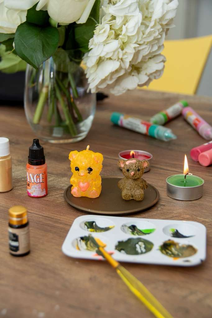 Bright paraffin bear candles with a paint palette