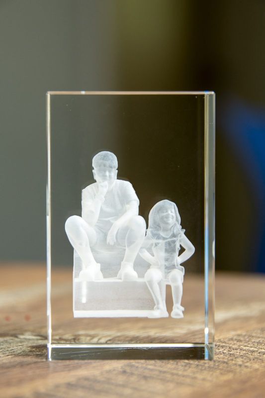 A laser-etched crystal block of a parent and child